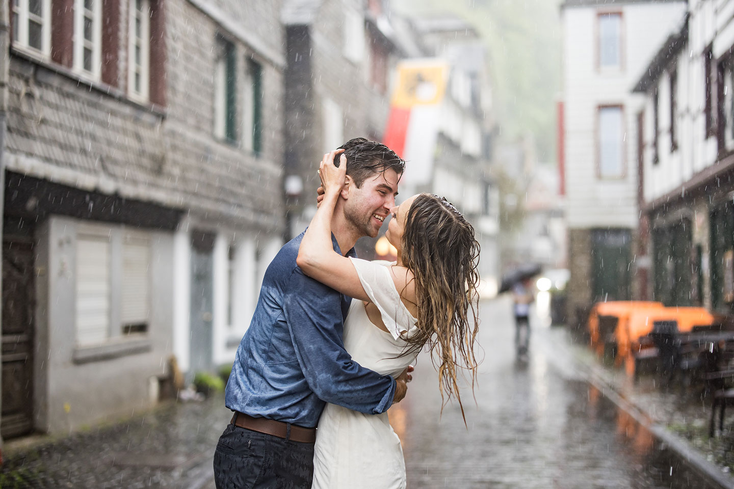 Couple in the rain in Monschau, Germany during their engagement shoot